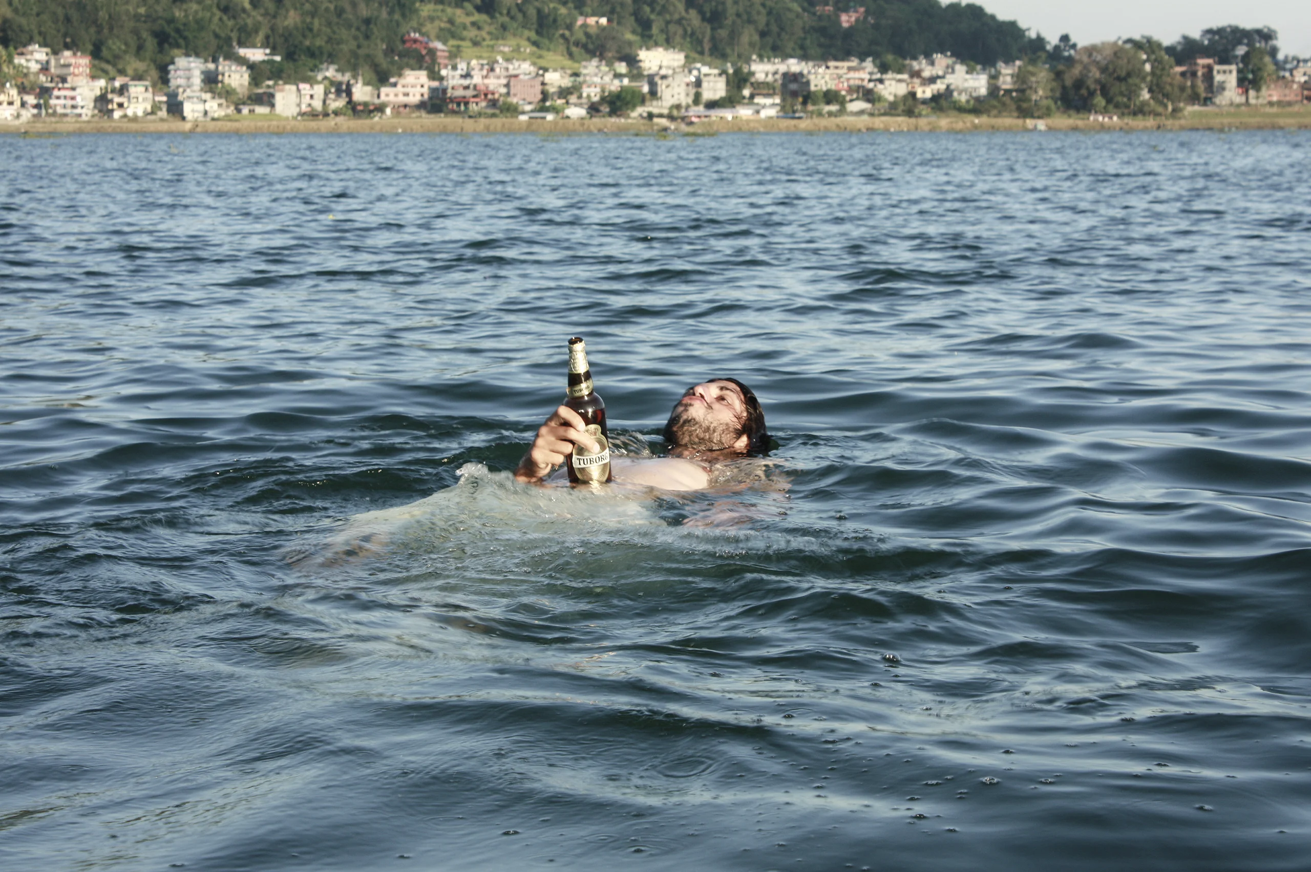 View from the lake Phewa with me taking a swim with a danish beer in hand